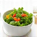 Stylized icon representing healthy food: a bowl of vibrant salad with a fork.