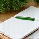 Open notebook with green pen, symbolizing daily blog content for wellness